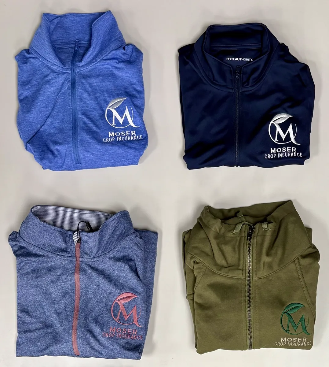 Embroidered quarter-zips arranged for a company apparel order