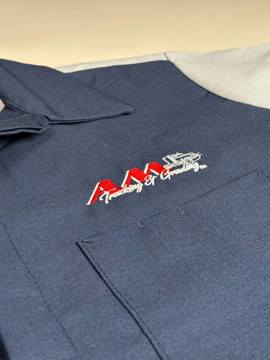Close-up of embroidered branding on a custom apparel piece