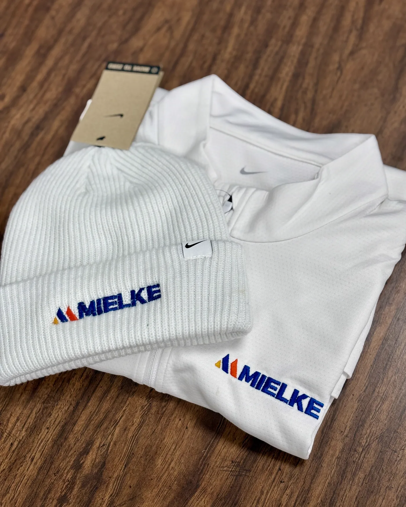 Commercial embroidery machine stitching a company logo onto fabric